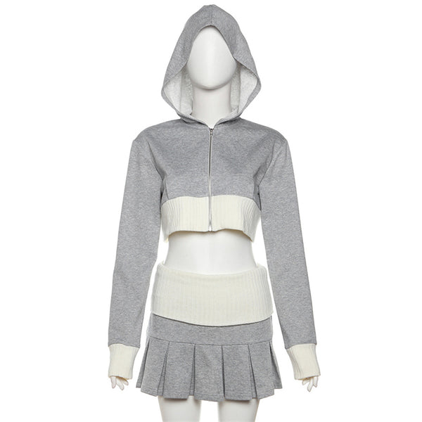 Cropped hoodie with ribbed accents paired with a high-waisted pleated skirt for a sporty and chic coordinated outfit.