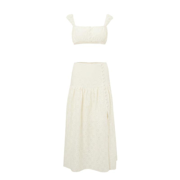 White eyelet embroidered two-piece set featuring a cropped top and a high-waist skirt with a side slit.