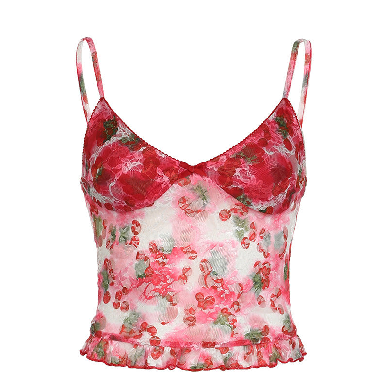 Floral sheer mesh camisole with red and green print, ruffle hem, styled with denim for a chic summer look.