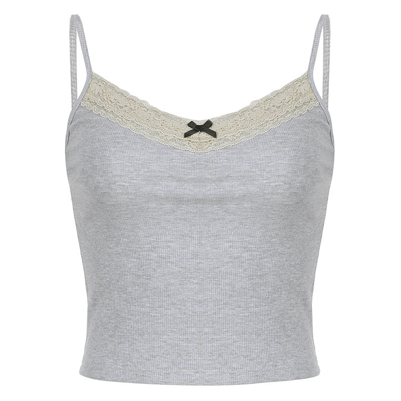 Grey ribbed cami top with lace trim and a black bow, paired with jeans for a chic, casual look.