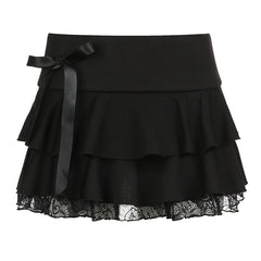 Black layered mini skirt with ruffles, lace trim, and a satin bow detail, perfect for a chic and playful style.