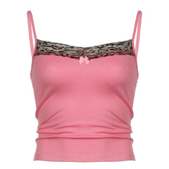 Pink camisole with leopard lace trim and bow detail, styled casually with denim for a trendy look.