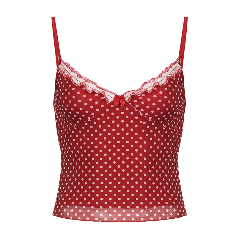 Red sheer camisole with white polka dots, lace trim, and bow detail, styled with a white skirt for a vintage-inspired look.